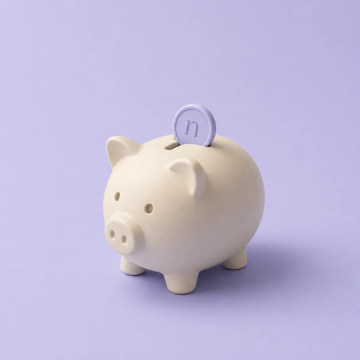 A ceramic piggy bank with a coin dropping into it